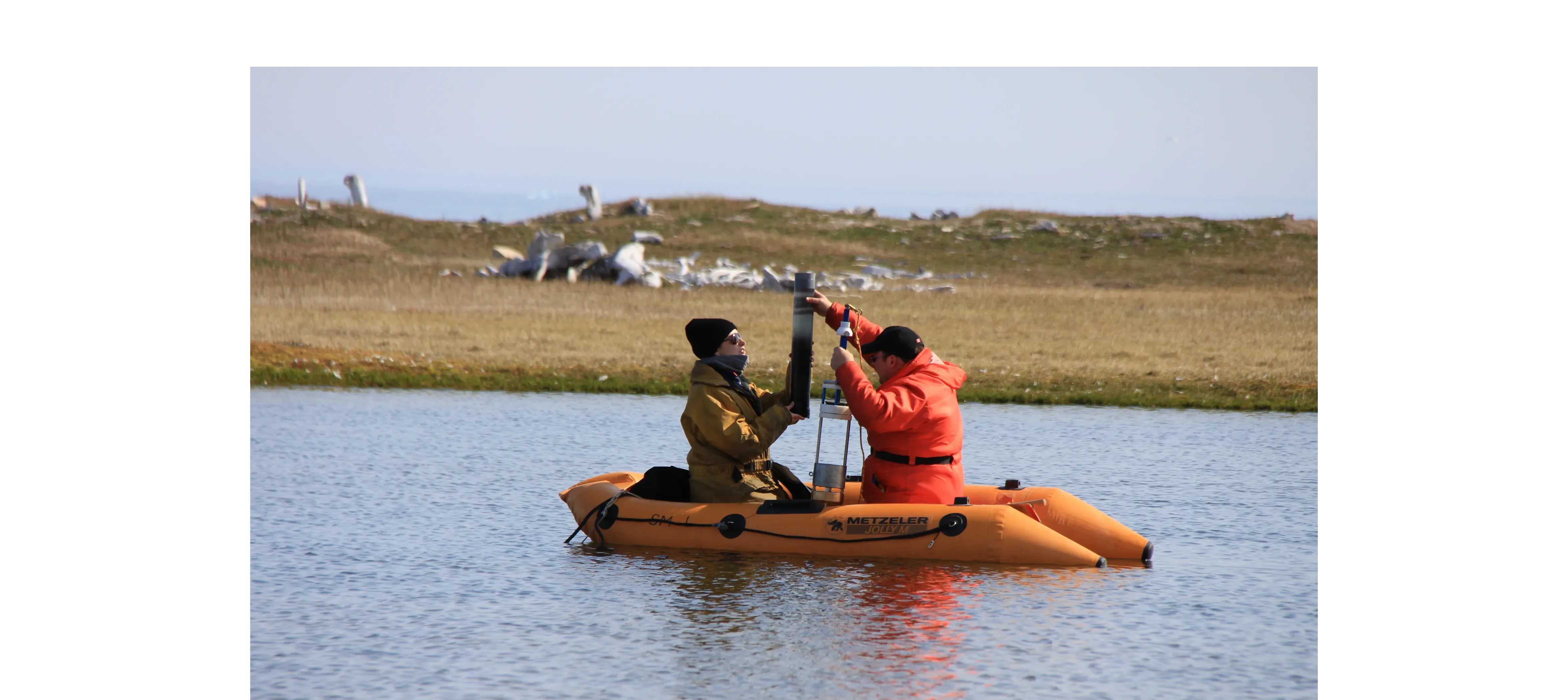 Sediment core collection with Thule whalebone houses in background